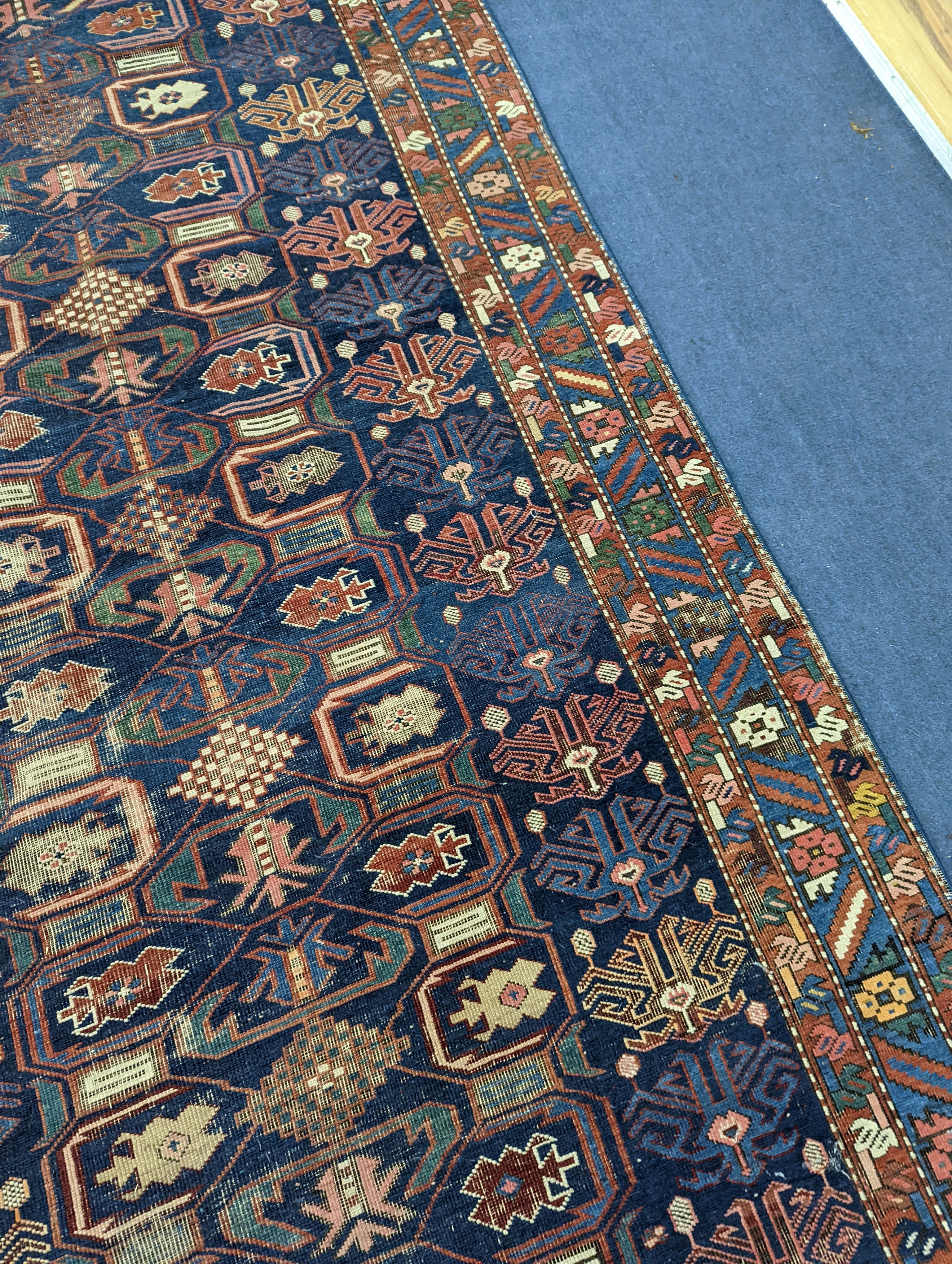 An antique Caucasian blue ground rug, 260 x 130cm